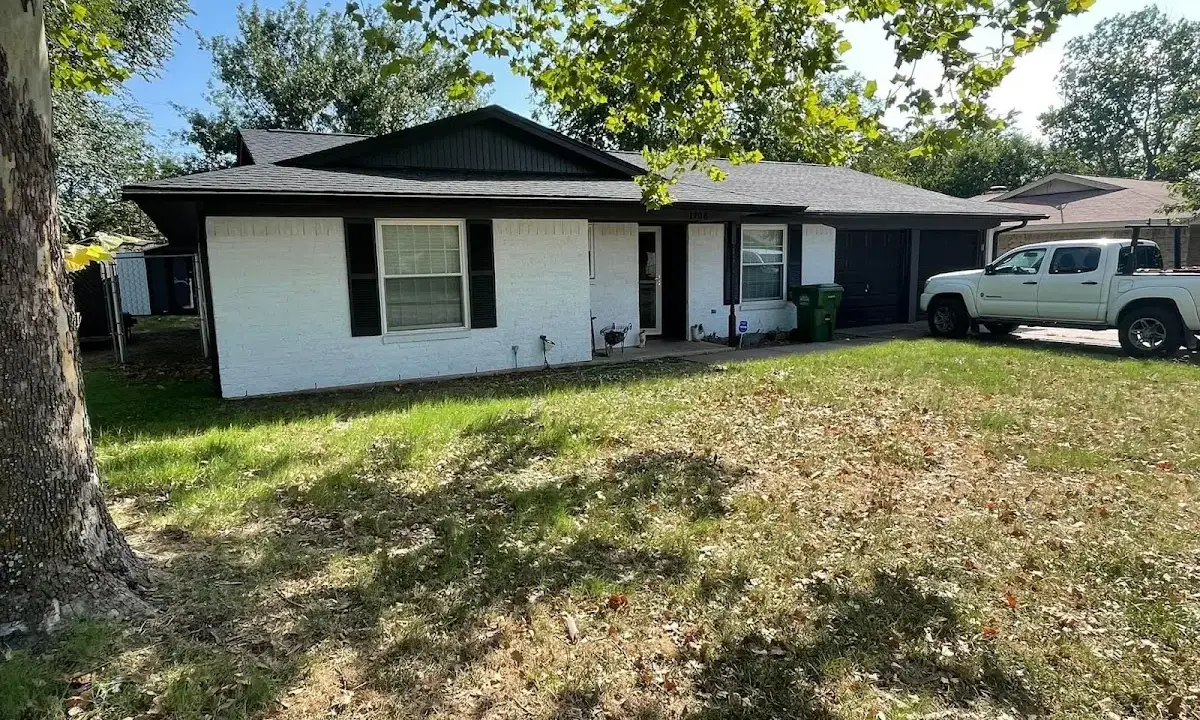 Professional roofing crew working on a residential roof in Oakton